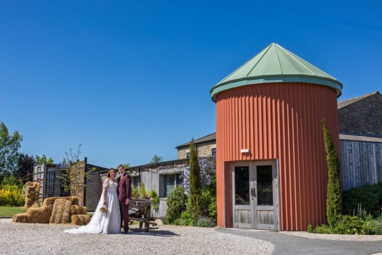 A bride and groom enjoying the sunshine on their special day, captured by Durham wedding photographer